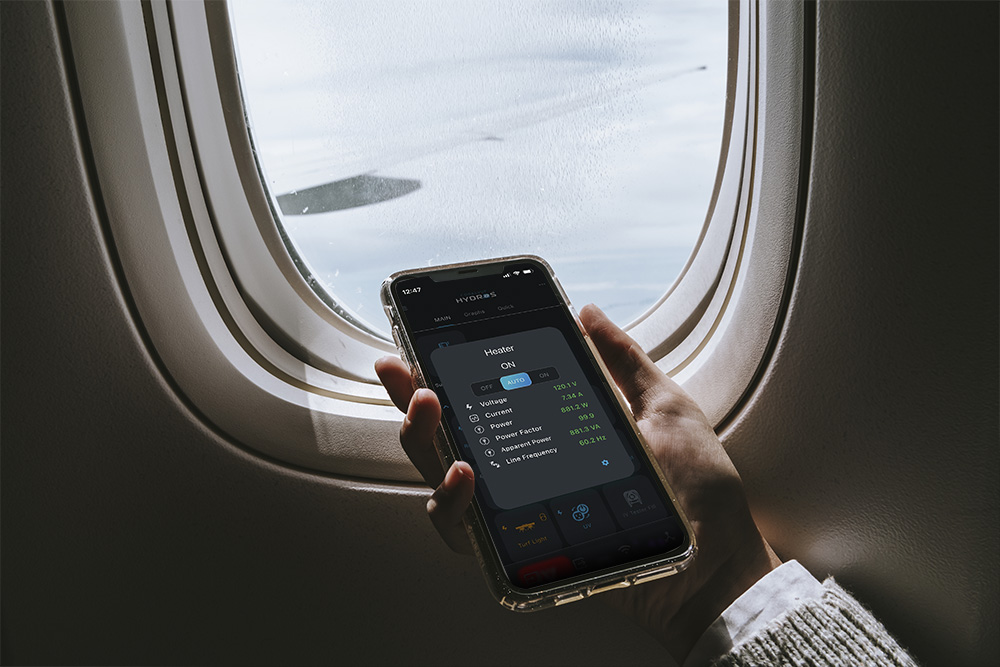 Looking_at_HYDROS_App_on_Phone_on_Airplane_-_Vacation